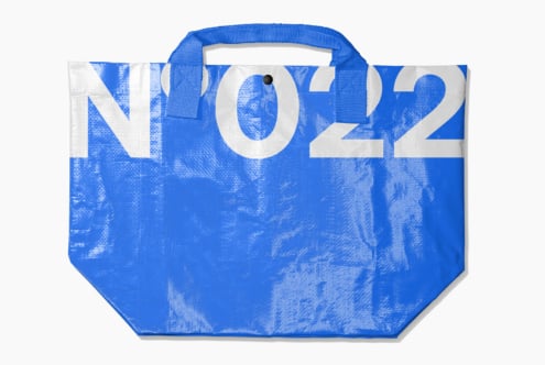 Blue plastic tote bag mockup with large white numbers, textured fabric surface