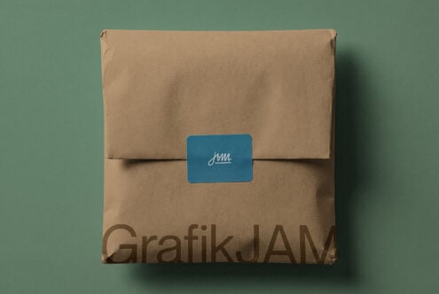 Kraft cardboard box with blue label showing cursive jam logo on sage green background