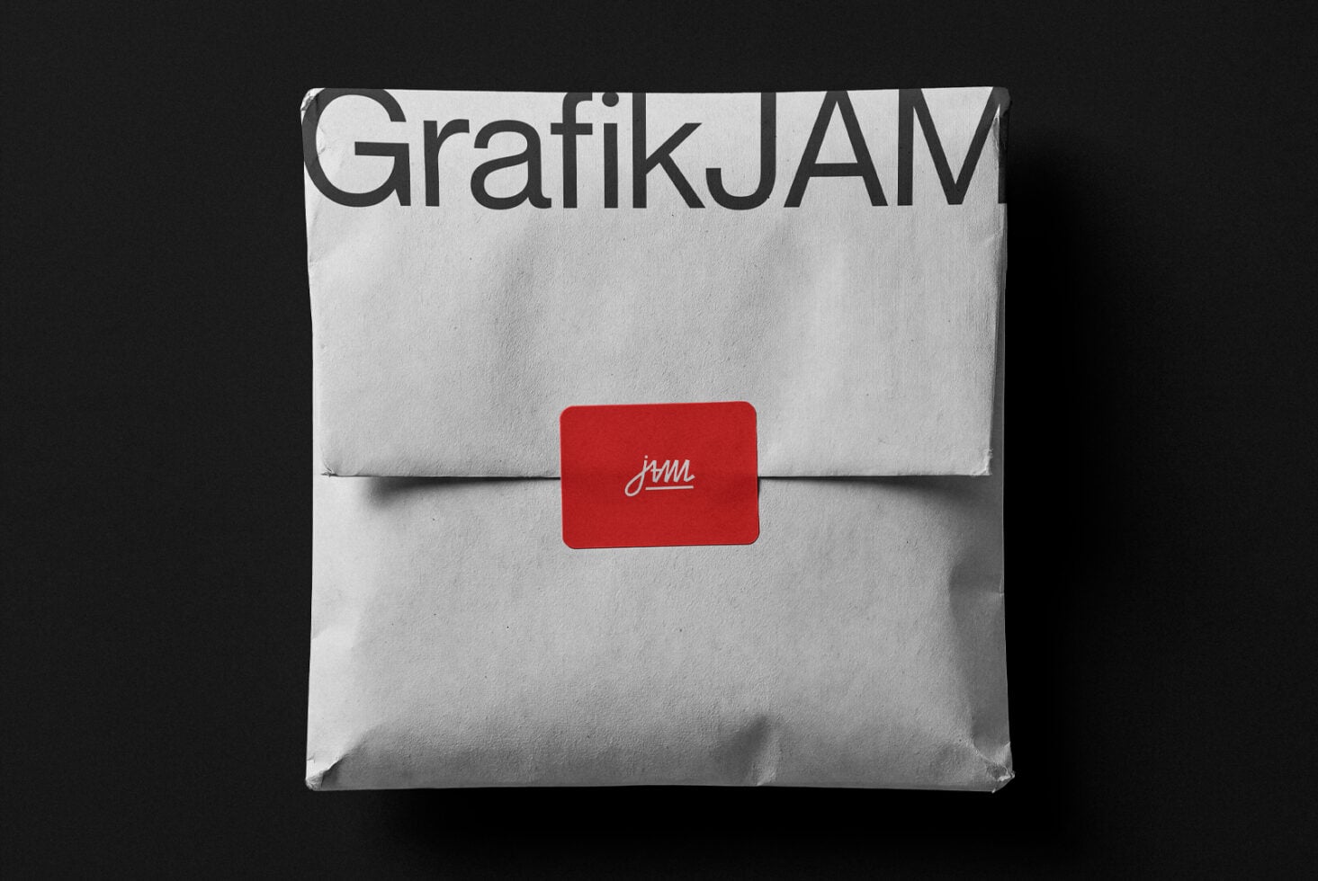 White envelope mockup with GrafikJAM branding plus red seal label on dark background