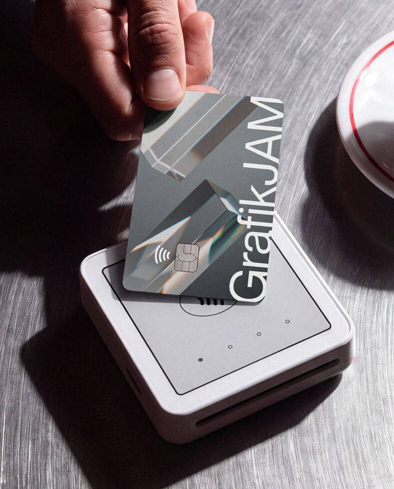 Hand tapping holographic credit card on payment terminal mockup