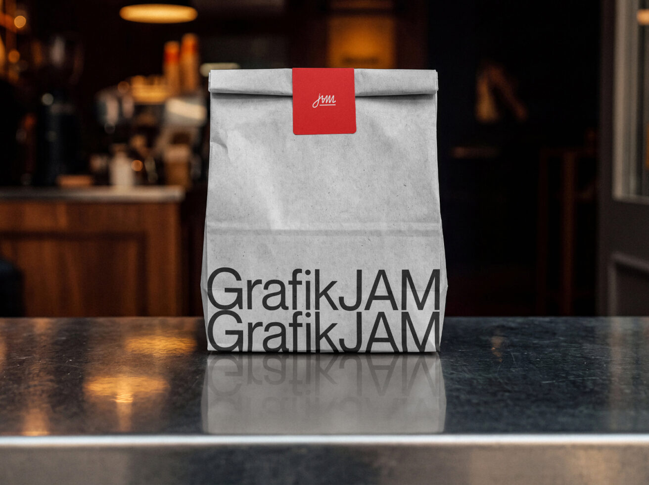 Kraft paper bag with red label on dark counter, cafe background out of focus