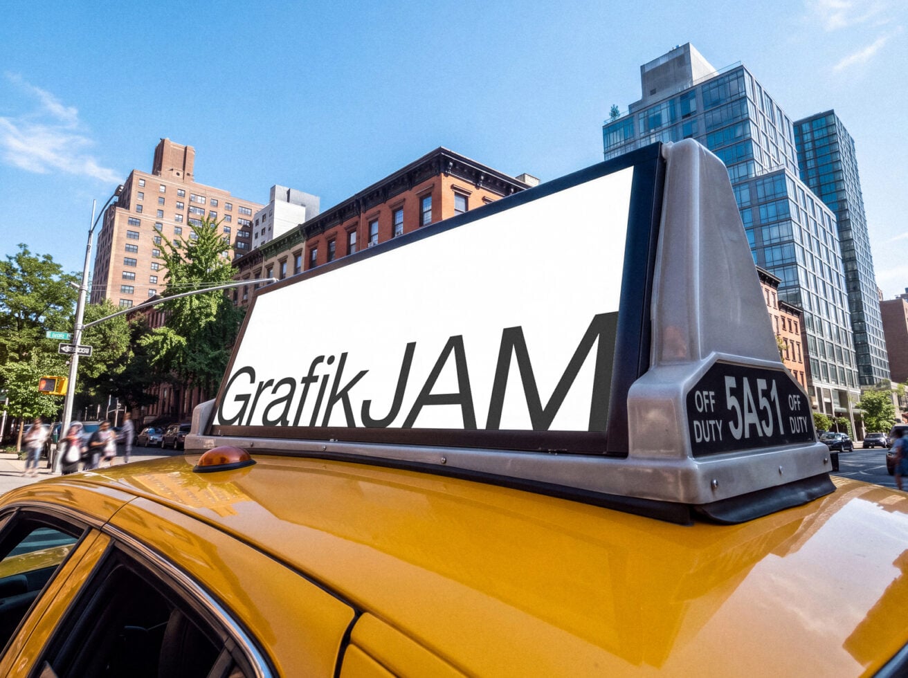 Oversized taxi cab roof sign mockup with GrafikJAM text on NYC street with buildings