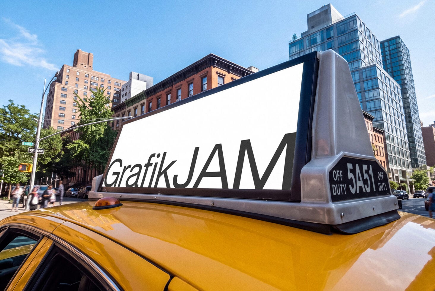 Oversized taxi roof sign mockup with GrafikJAM branding on yellow cab in NYC street scene