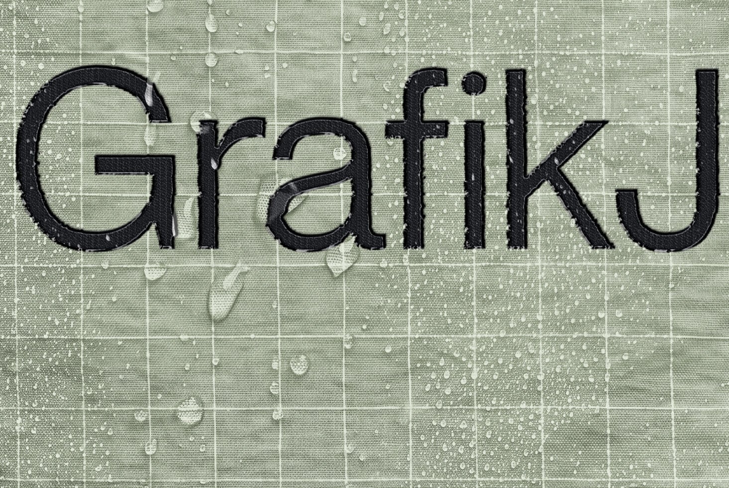 Bold black serif letters spelling Grateful on textured green tile background with grid pattern