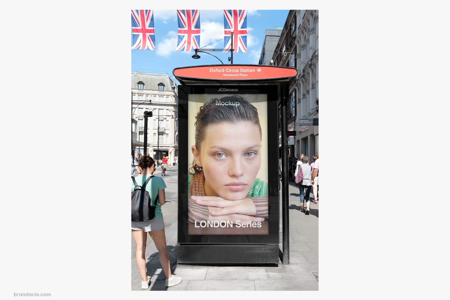 Bus shelter ad mockup at Oxford Circus with Union Jack flags overhead, London street scene
