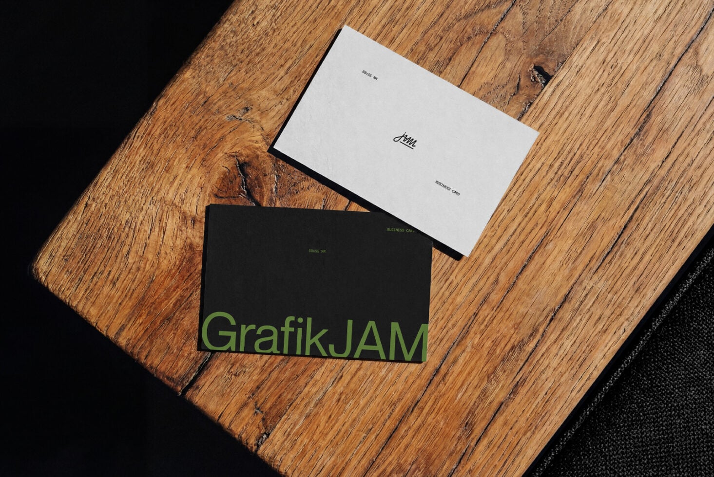Business cards mockup with white, black designs on wooden surface with fabric