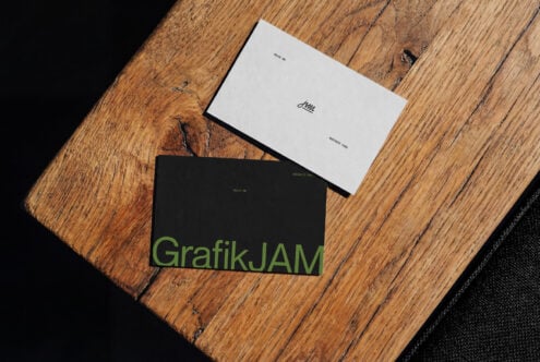 Business cards mockup with white, black designs on wooden surface with fabric
