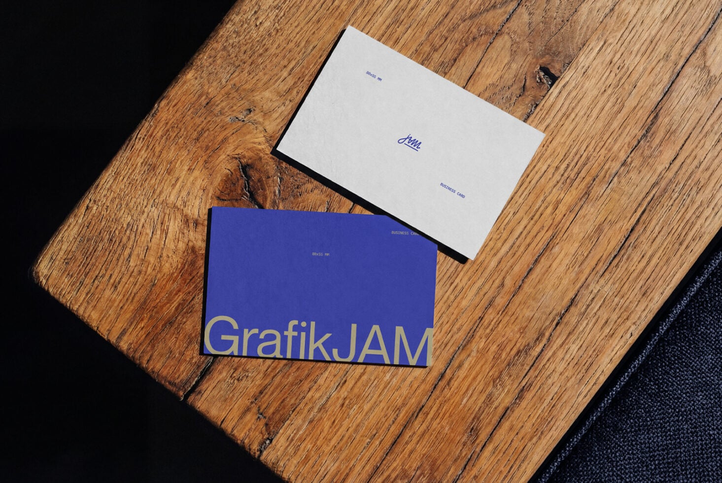 Blue business cards with gold foil stamping on rustic wood surface