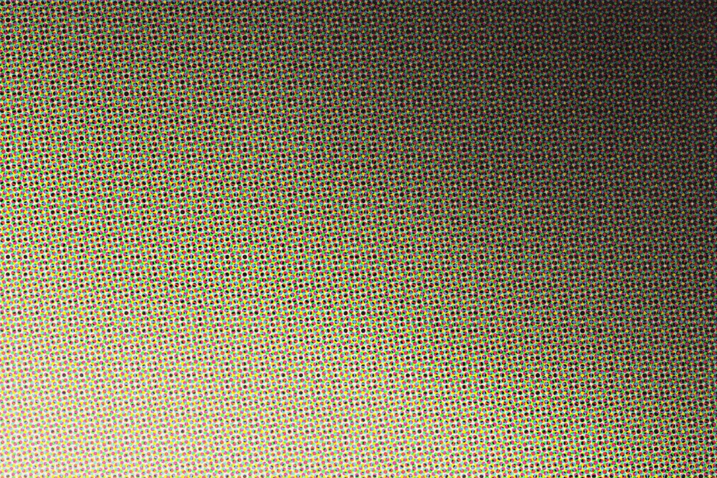 Colorful halftone dot pattern fading from bright yellow to dark charcoal, retro print style