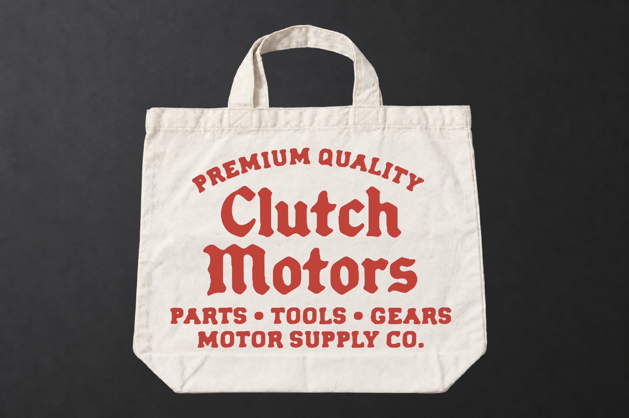 Cream canvas tote bag with bold red vintage lettering for Clutch Motors parts shop