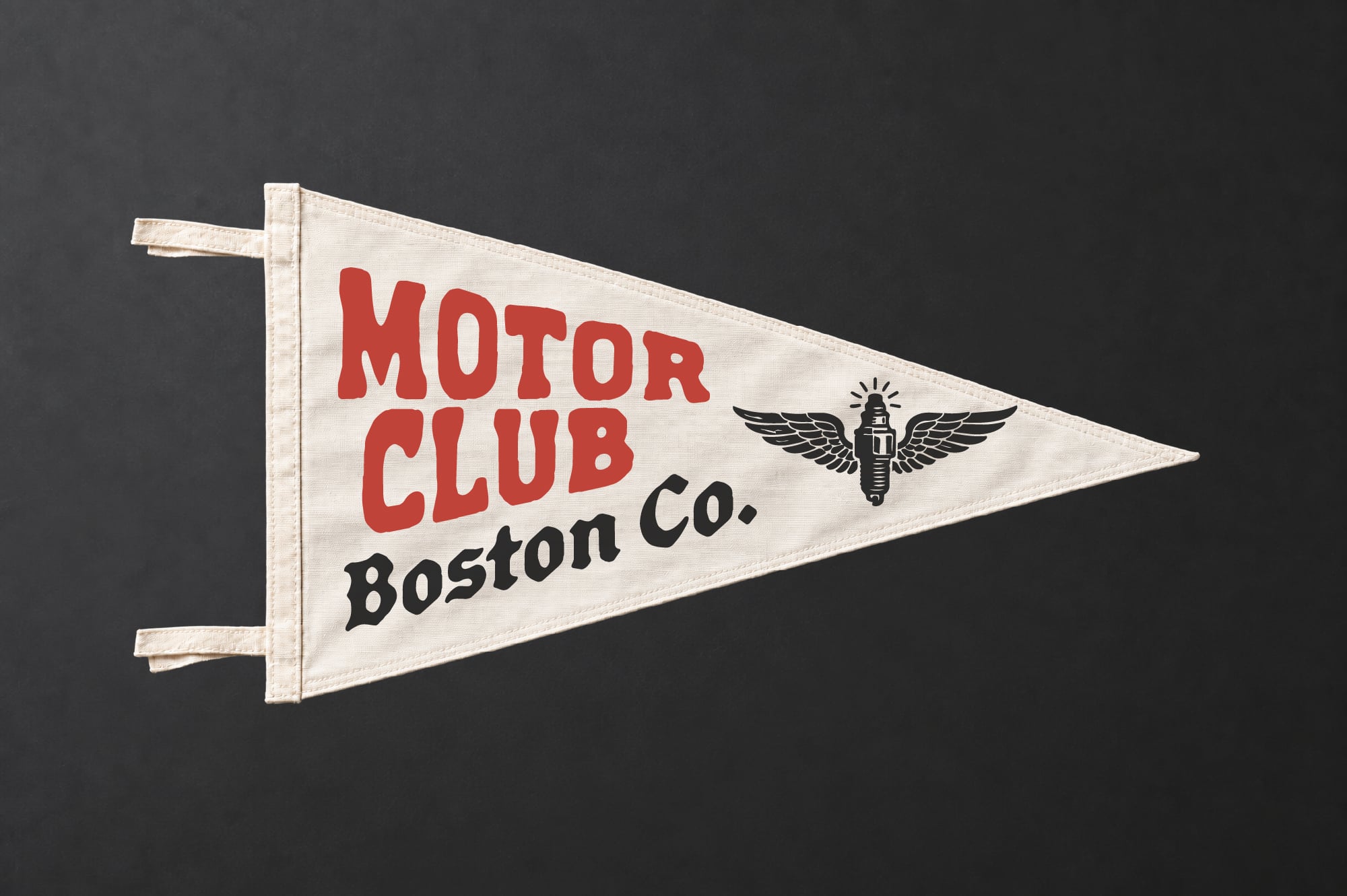 Vintage pennant flag mockup with red Motor Club Boston Co. text plus winged spark plug logo on cream fabric