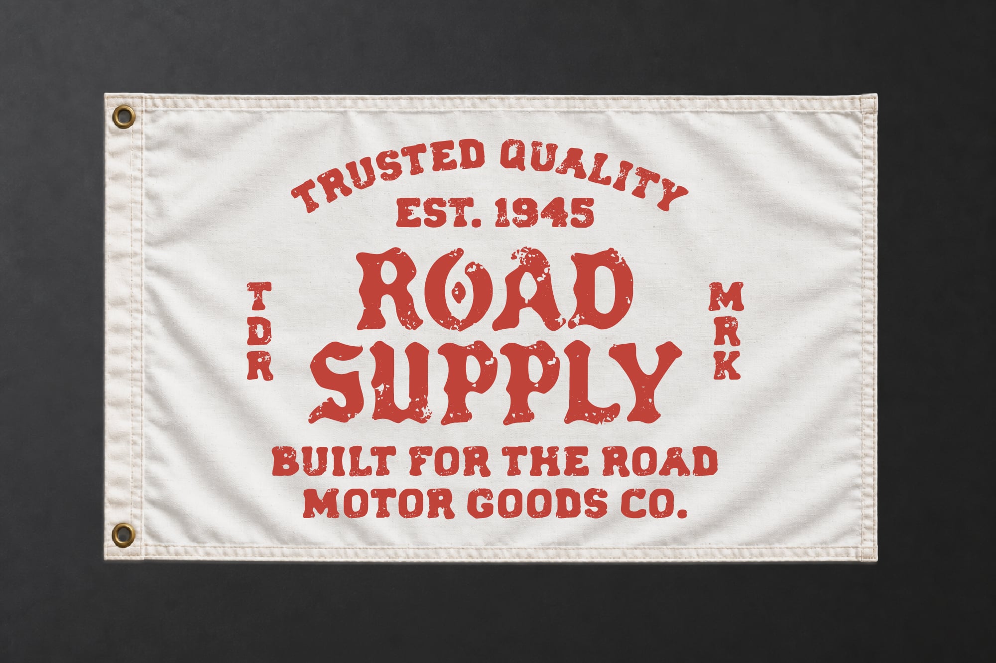 Vintage canvas flag with red distressed lettering reading "Road Supply Est. 1945" for retro branding
