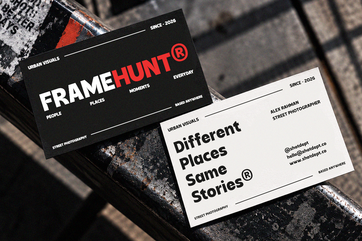 Two business cards with minimalist design, one black with red accents, one cream, both featuring street photography branding on textured surface