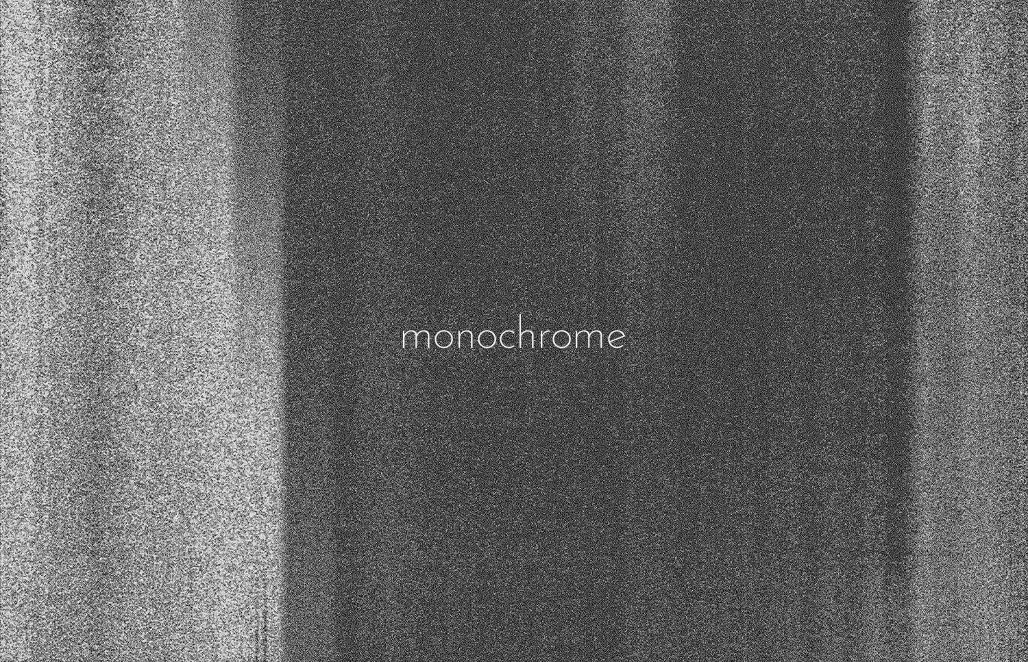 Grainy monochrome texture with soft light streaks, minimal typography centered in frame