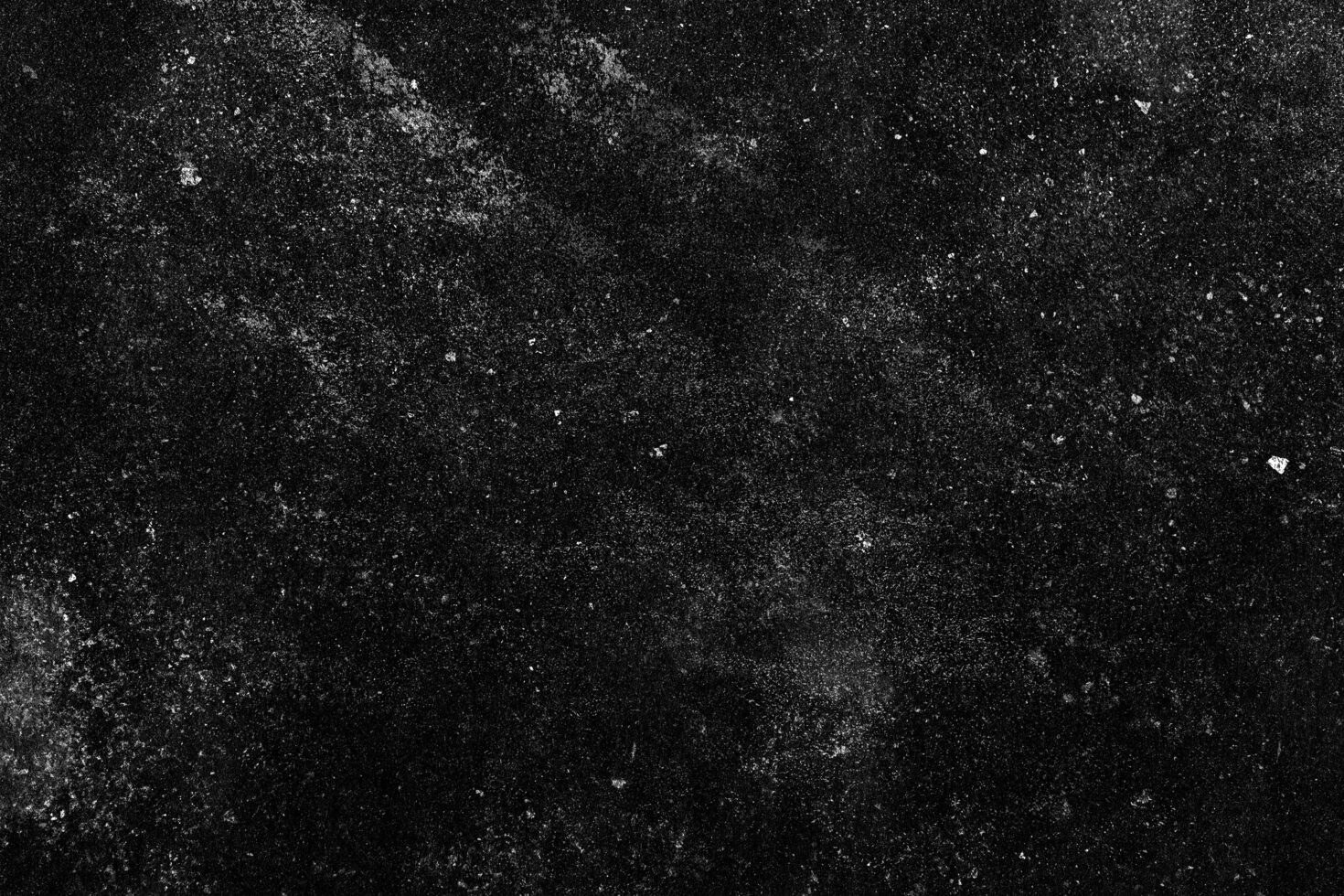 Grainy black background with white noise texture scattered throughout