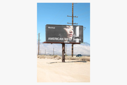 Vintage roadside billboard mockup in desert landscape with mountains