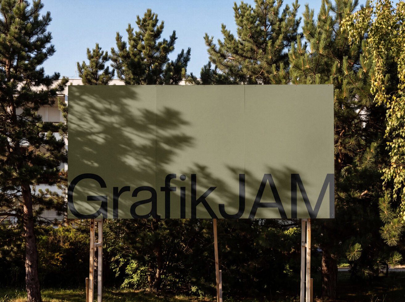 Outdoor billboard mockup with sage green panel surrounded by tall pine trees with dappled sunlight