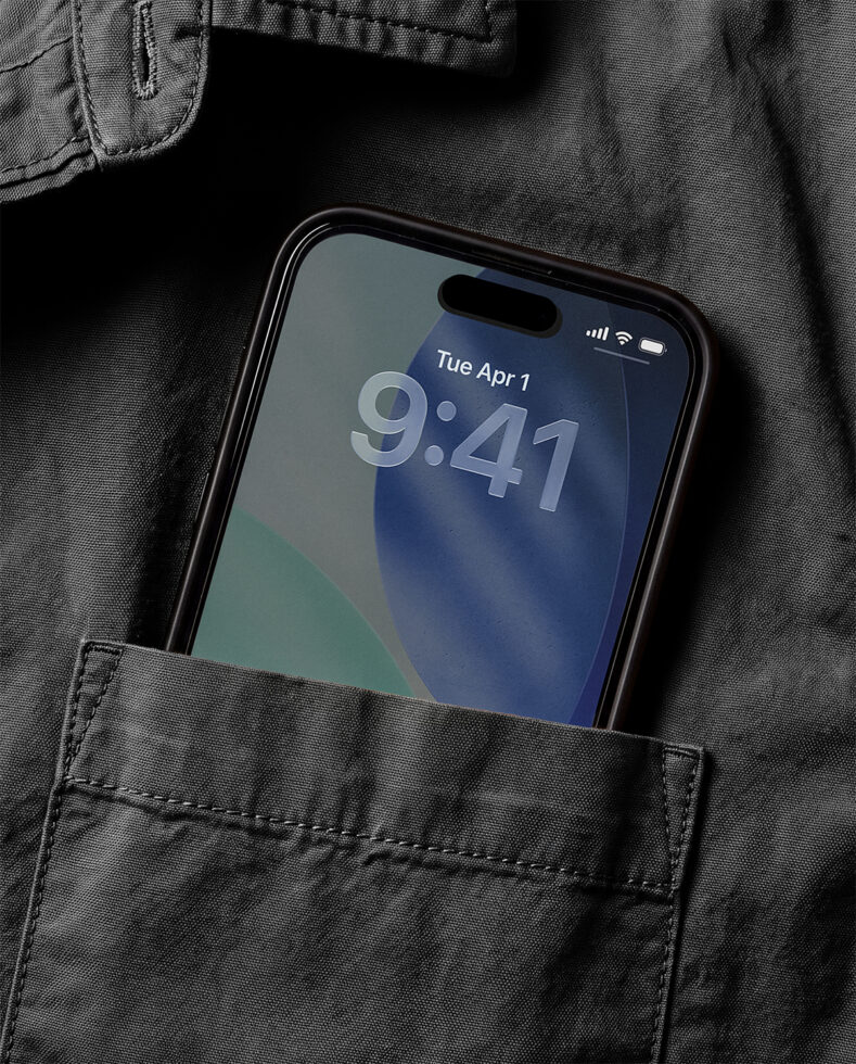 iPhone 14 Pro mockup tucked in jacket pocket showing lock screen with time