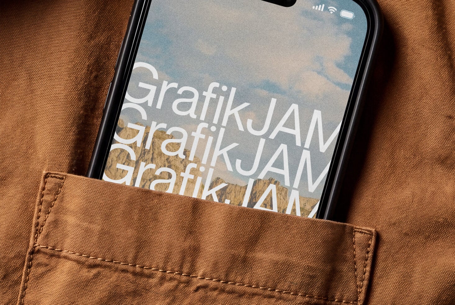 Black iPhone in brown canvas pocket showing layered white text over sky landscape