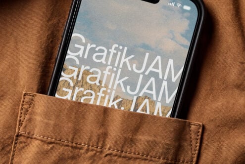 Black iPhone in brown canvas pocket showing layered white text over sky landscape