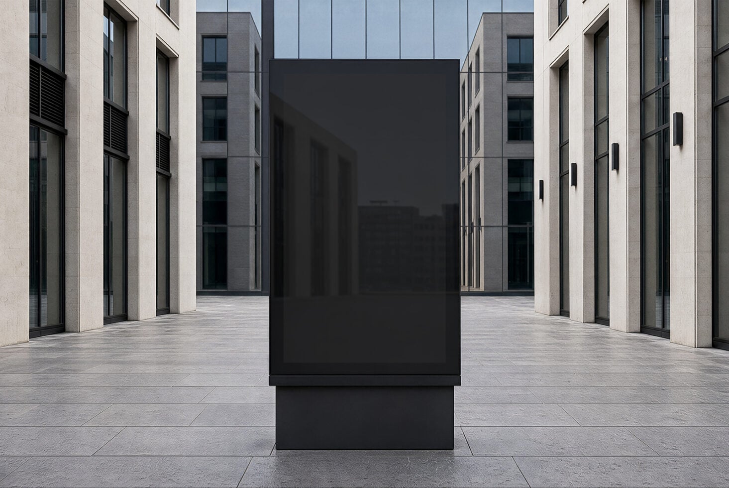 Black billboard mockup in modern courtyard between concrete buildings