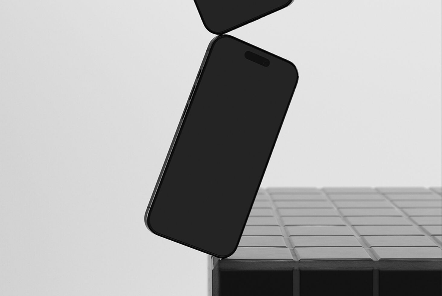 Black iPhone flip case mockup tilted against textured surface with minimal background