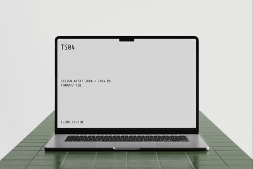 Laptop mockup on green tile surface with editable screen displaying specs