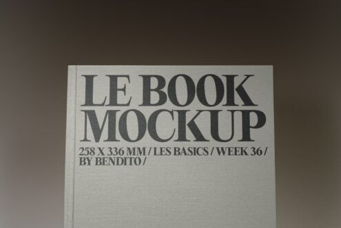 Hardcover book mockup with minimalist serif typography on cream linen cover, angled view
