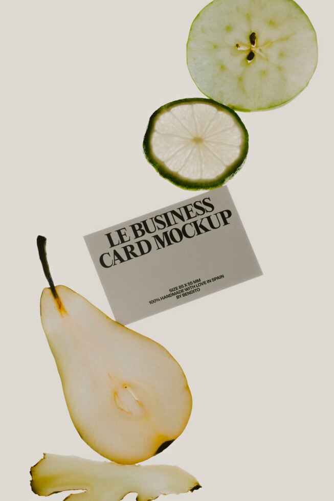 Business card mockup with lime slices, pear half, fresh ginger on clean white background