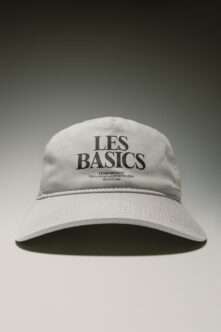 White baseball cap mockup with Les Basics branding on front panel, clean minimal product shot