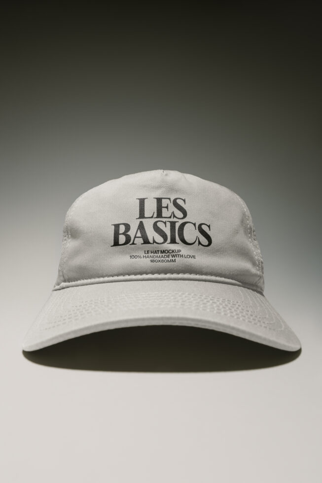 White baseball cap mockup with Les Basics branding on front panel, clean minimal product shot