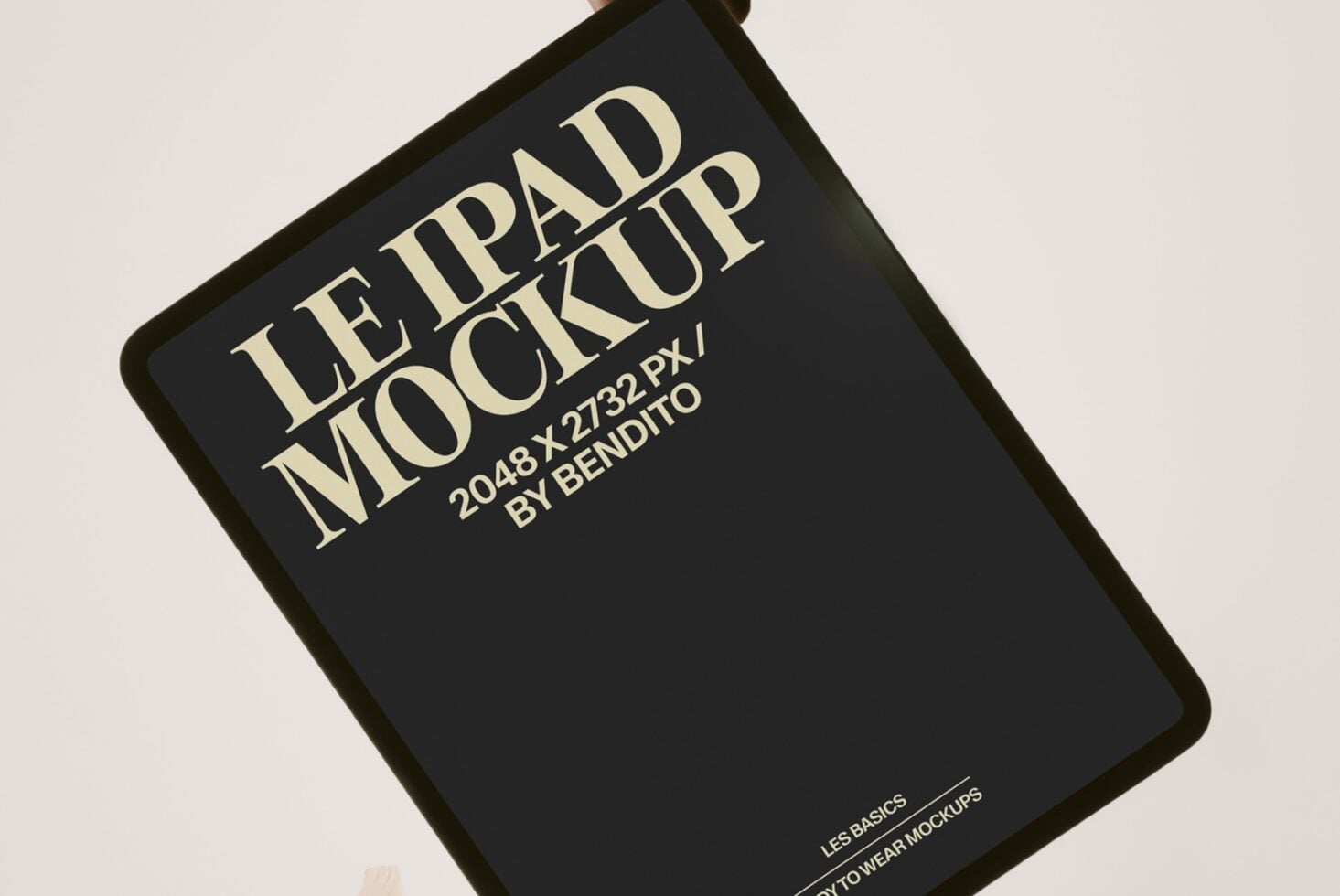 Angled black book cover mockup with cream serif type showing Le Ipad Mockup title
