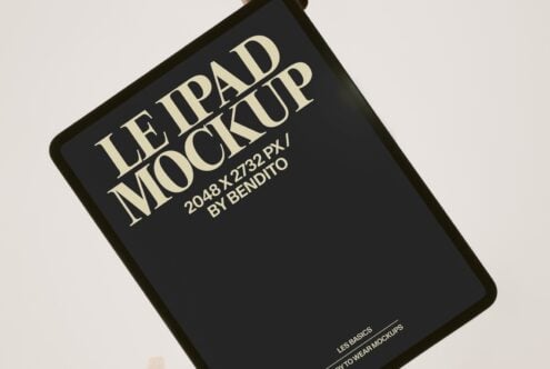 Angled black book cover mockup with cream serif type showing Le Ipad Mockup title