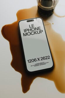 iPhone 14 Pro mockup held in hand with coffee cup, moody shadows, clean minimal setup