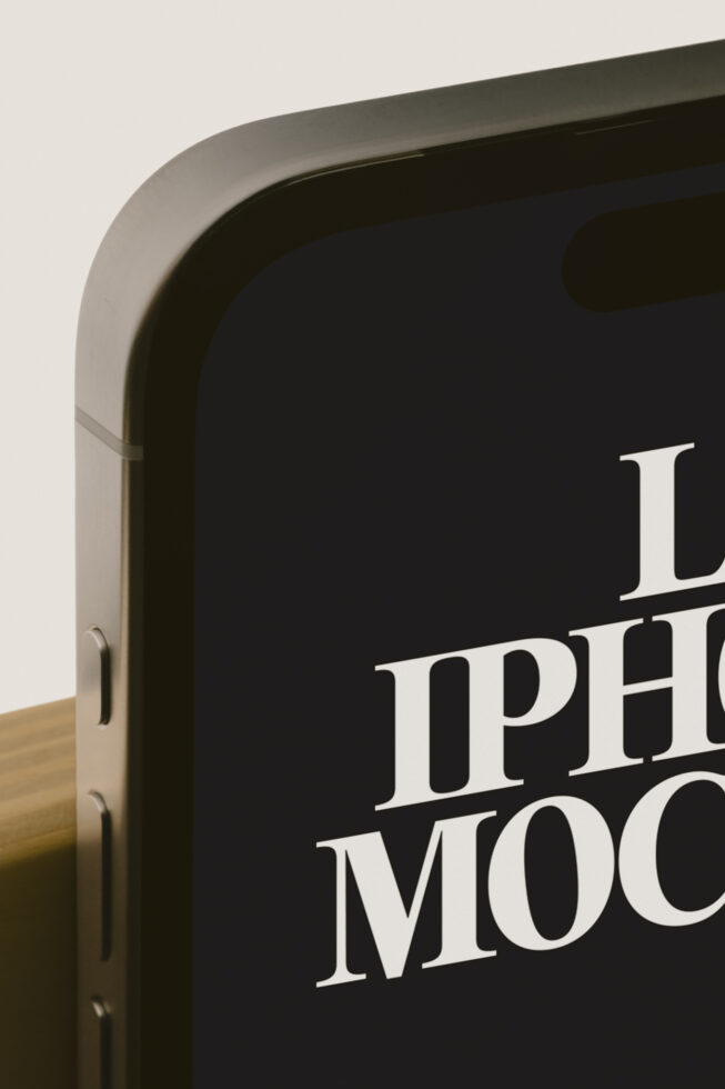 Close-up of rounded monitor frame displaying serif typography on dark screen with wooden base visible