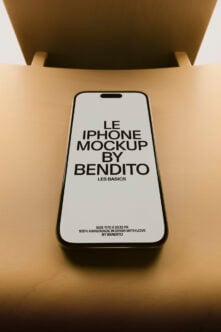 iPhone mockup overhead shot with warm tan background, black frame device on beige surface