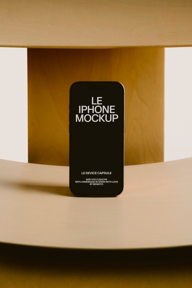 Black iPhone mockup on tan backdrop with curved gold wall elements