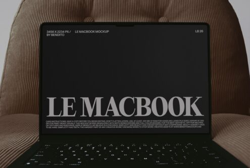Macbook laptop mockup on tan ribbed fabric with large serif typography on screen