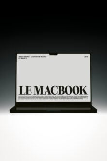 MacBook laptop mockup with large serif typography on minimal screen display