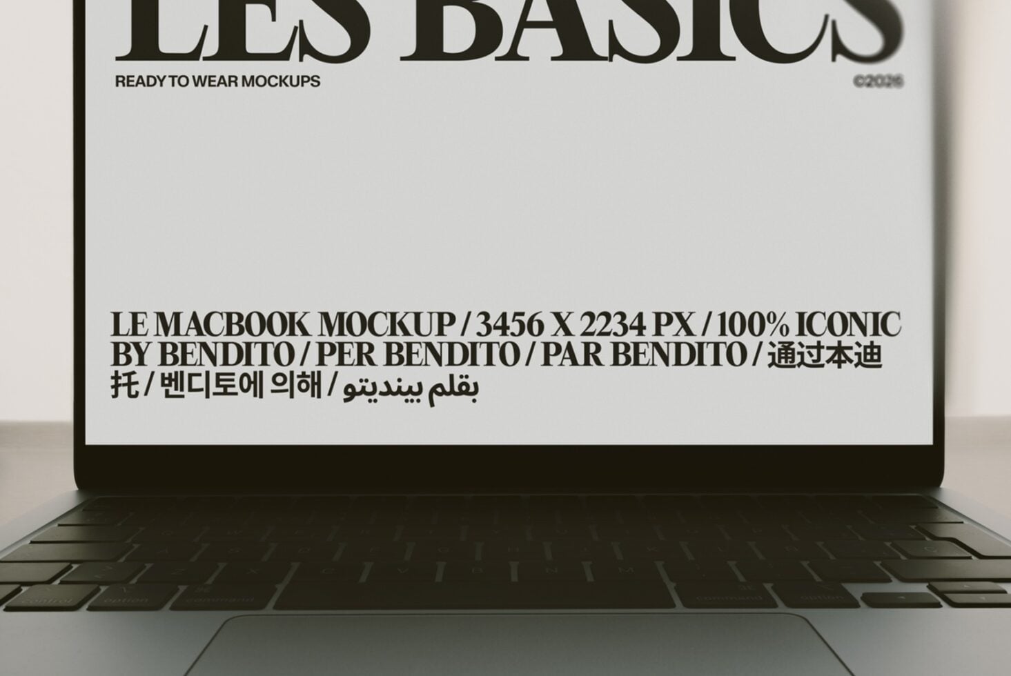 Macbook screen displaying multilingual typography layout with bold serif text over minimalist beige background