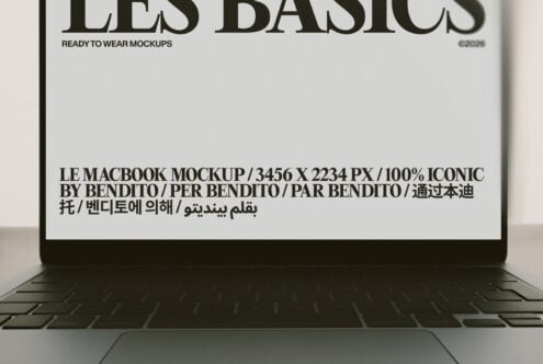 Macbook screen displaying multilingual typography layout with bold serif text over minimalist beige background