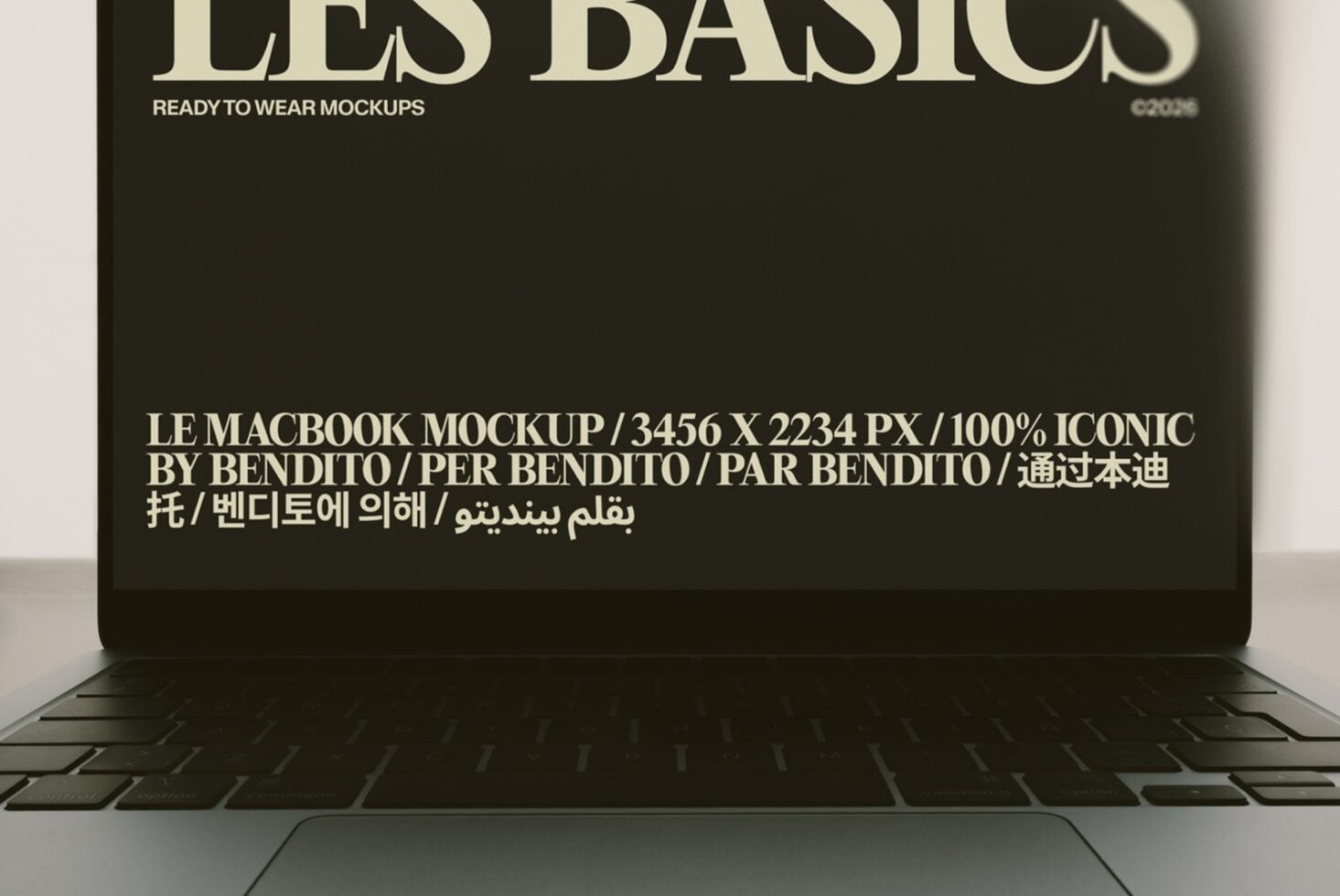 MacBook mockup displaying multilingual text on dark screen with keyboard visible