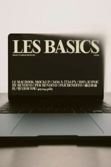Les Basics MacBook mockup with cream serif type on dark screen by Bendito