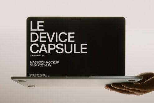 Macbook held in hand with "Le Device Capsule" text on screen, minimalist mockup