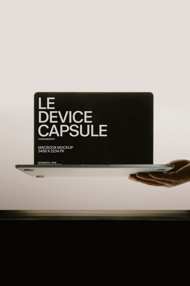 Hand holding MacBook with black screen showing "Le Device Capsule" text mockup