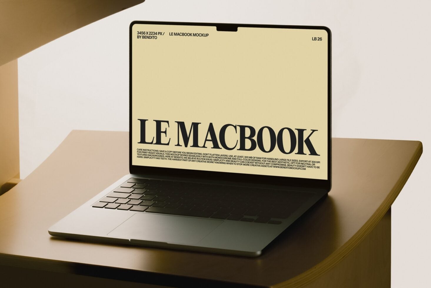 MacBook mockup with cream display showing bold serif typography on warm neutral background