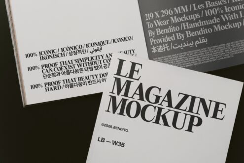 Open magazine mockup showing multilingual typography with black serif text on white pages, dark cover in background
