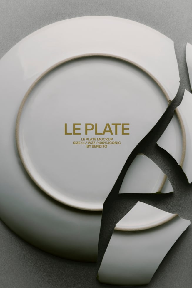 Elegant ceramic plate mockup with gold text branding, shot overhead with black ribbon accent