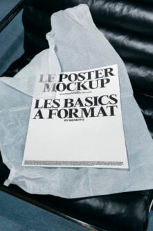 Folded poster mockup on black leather chair with tissue paper wrapping