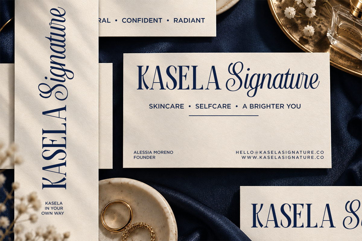 Luxury skincare brand identity mockup with navy script typography on cream business cards, navy fabric background, gold accents with dried flowers